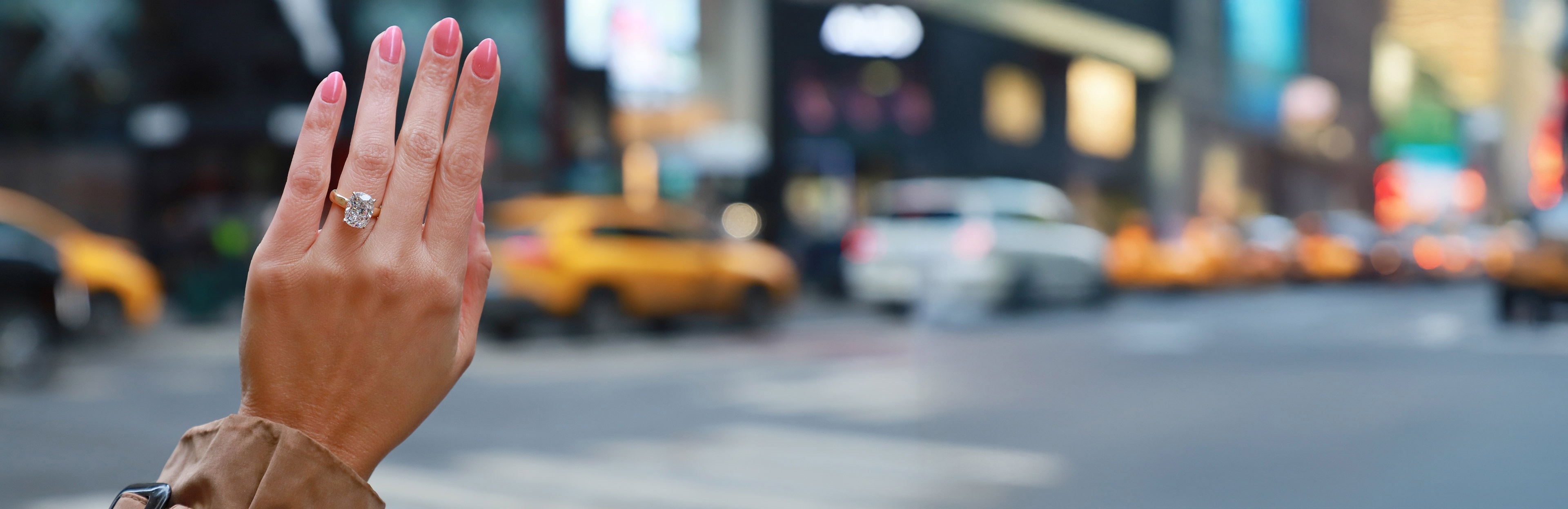 oval diamond three stone engagement ring on hand