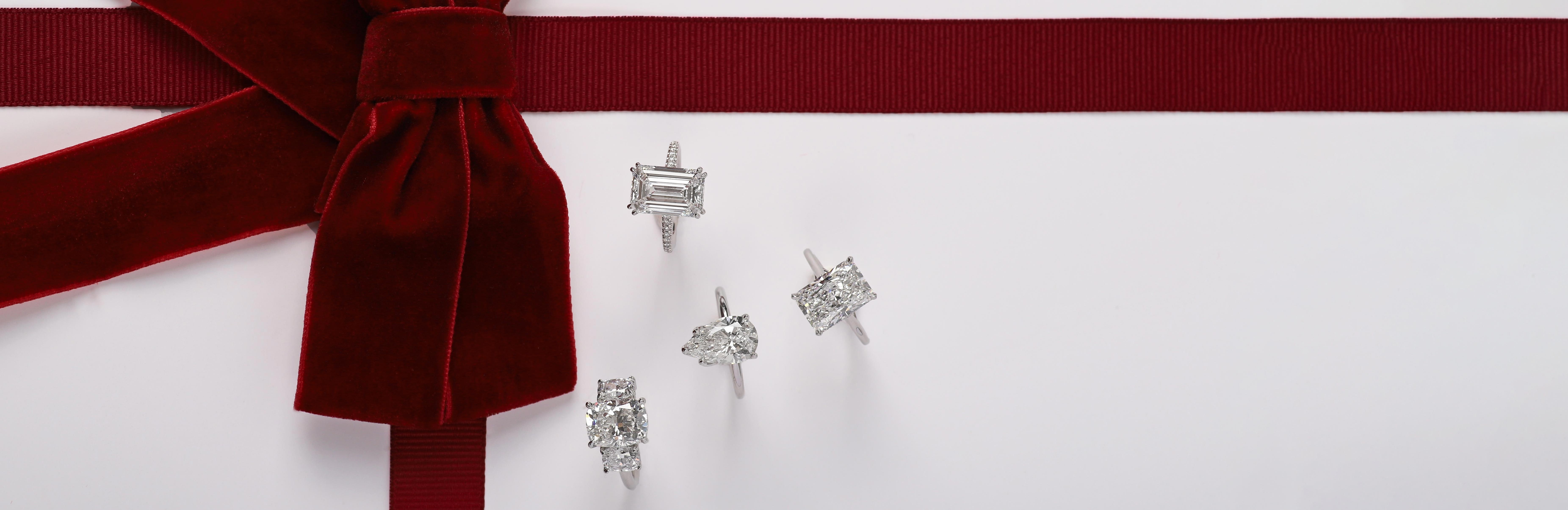 model wearing five engagement rings over green marble countertop