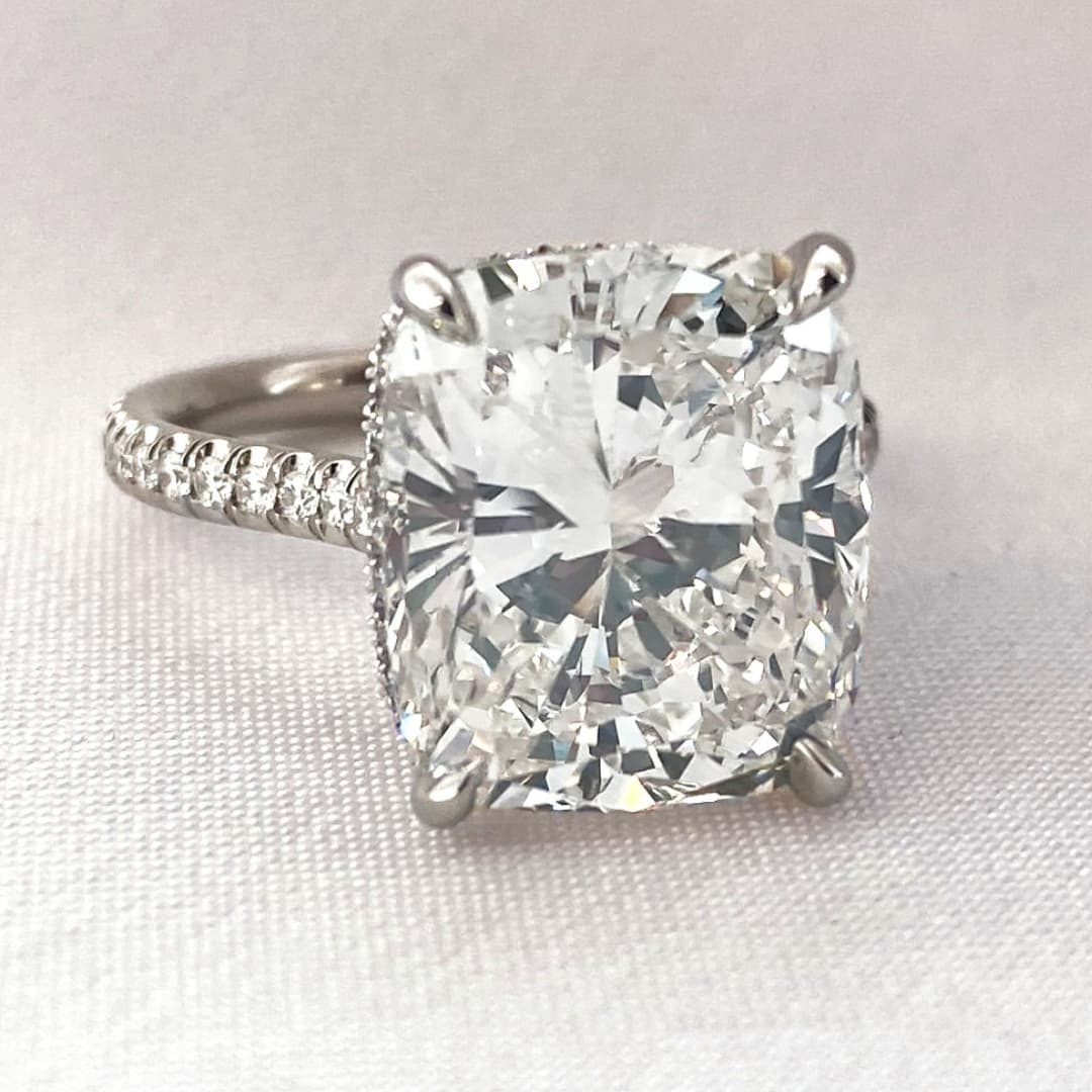 four various engagement ring styles on ladies hand