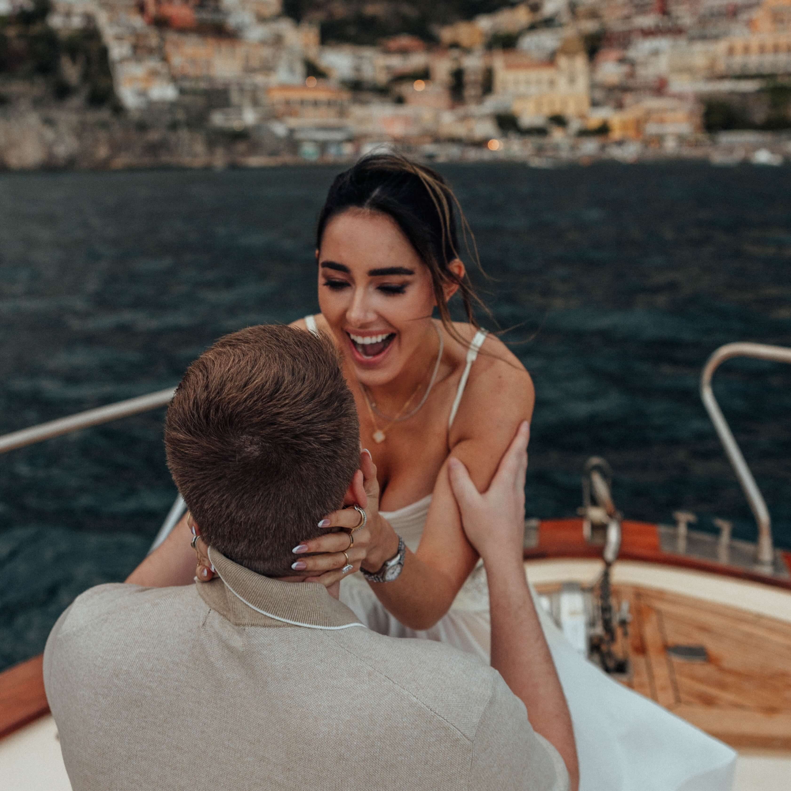 Engaged Couple Embracing on a Boat.